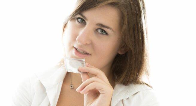Opening the condom packet with your teeth or nails