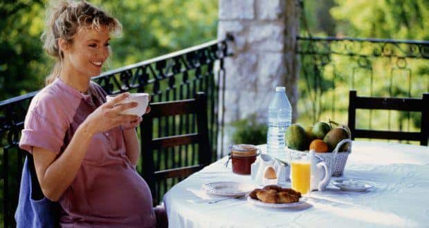 pregnant woman drinking coffee