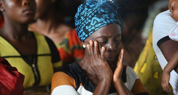 DOLO TOWN, LIBERIA - AUGUST 24: Church members pray as the pastor speaks about the Ebola epidemic during a Sunday service at his church on August 24, 2014 in Dolo Town, Liberia. Members of the Bethlehem World Outreach Ministry International prayed for Liberia's healthcare workers, who have become some of the Ebola epidemic's most frequent casualties. The government issued a quarantine August 20 to stop the Ebola epidemic from spreading from the rural community of some 20,000 people, located near Liberia's international airport, and the military is stopping residents from leaving the area. Local Ministry of Health personnel say they have sent 20 sick people in the previous days to the Doctors Without Borders (MSF), treatment center for to be tested for Ebola. (Photo by John Moore/Getty Images)