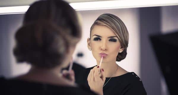 applying lip gloss for shine