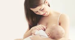 What causes pain while breastfeeding?