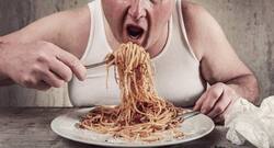 What should you do to ease discomfort when you overeat?