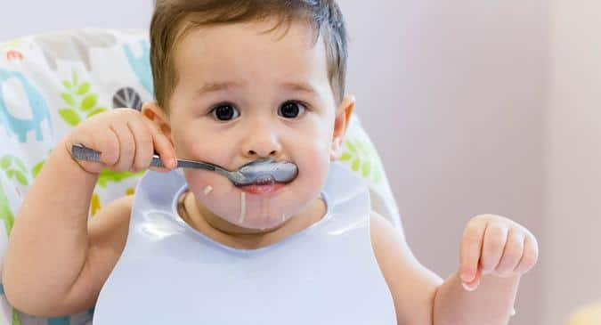 toddler eating spoon