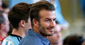 David Beckham flaunts abs at 39