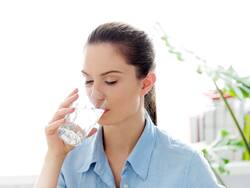 Should I Drink Water While Standing Or Sitting?